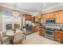 Kitchen features stainless appliances, granite counters, a decorative chandelier, and ample cabinet space, perfect for cooking and dining at 9415 Rosalyn Glen Rd, Cornelius, NC 28031