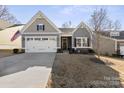 Gray craftsman style home with a two-car garage and American flag at 10225 Black Locust Ln, Charlotte, NC 28215