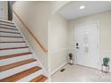 Bright entryway with staircase, tile flooring, and potted plants at 104 Brookview Dr, Shelby, NC 28152