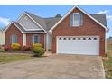 Brick ranch house with attached garage and well-maintained lawn at 104 Brookview Dr, Shelby, NC 28152