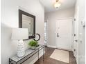 Inviting entryway with modern console table, mirror, and neutral decor at 11735 Ridgeway Park Dr, Charlotte, NC 28277