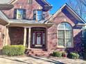 Brick facade with a charming red door and arched window at 1180 Asheford Green Ave # 46, Concord, NC 28027