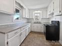 Renovated kitchen with white cabinets and grey countertops at 1215 Neal Hawkins Rd, Gastonia, NC 28056