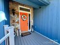 Bright orange front door with wreath and gray composite deck at 1432 Jules Ct, Charlotte, NC 28226