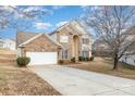 Two-story brick home with a white garage door and driveway at 16737 Winston Oaks Ct # 297, Charlotte, NC 28213