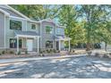 Newly built townhouses with landscaping, brick accents, and gray siding at 1750 J Julian Ln, Charlotte, NC 28208