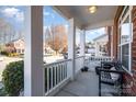 Covered porch with bench, offering a relaxing outdoor space at 20215 Middletown Rd, Cornelius, NC 28031