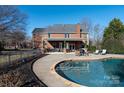 Inviting in-ground pool with a spacious patio and covered area at 21711 Shoveller Ct, Cornelius, NC 28031