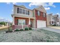 Two-story brick house with a covered porch and attached garage at 2224 Apple Glen Ln, Charlotte, NC 28269