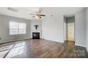 Living room with hardwood floors, fireplace, and access to a bathroom at 2224 Apple Glen Ln, Charlotte, NC 28269