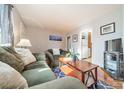 Bright living room with wood floors and a view into the kitchen at 2516 Columbus Cir, Charlotte, NC 28208