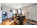 Living room with hardwood floors, sofa and entryway view at 2516 Columbus Cir, Charlotte, NC 28208