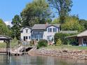 Lakefront home exterior showcasing expansive windows and deck at 2579 Ranger Island Rd, Denver, NC 28037