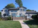 Back exterior view of home; features large deck and hot tub at 2579 Ranger Island Rd, Denver, NC 28037