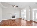 Spacious living room with a fireplace, large windows, ceiling fan and laminate floors at 2820 Rosemeade Dr, Monroe, NC 28110