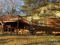 Elevated deck, brick home, and partial view of yard at 3326 Winterfield Pl, Charlotte, NC 28205