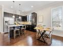 Modern kitchen with dark cabinetry, stainless steel appliances, and an island at 3551 Spencer St, Charlotte, NC 28205