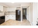 Renovated kitchen featuring white cabinets, granite countertops, and black appliances at 4762 Old Lantern Way, Charlotte, NC 28212