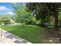 Landscaped yard with lush green grass and mature trees at 4762 Old Lantern Way, Charlotte, NC 28212