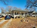 Cute bungalow with front porch, driveway and bird bath at 503 E 10Th St, Kannapolis, NC 28083