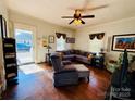 Living room with hardwood floors, sectional sofa, and armchair at 503 E 10Th St, Kannapolis, NC 28083