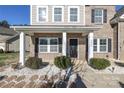 Inviting front entrance with a covered porch and stone accents at 5030 Monacan Way, Indian Land, SC 29707