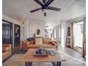 Inviting living room with leather sofa, wood floors, and a stylish ceiling fan at 5229 Mt Holly Huntersville Rd, Charlotte, NC 28216