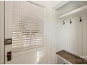 Bright entryway with built-in bench, hooks, and white door at 533 Wakefield Dr # B, Charlotte, NC 28209