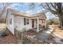 Side view of a ranch home with a walkway and small fence at 6208 Karenstone Dr, Charlotte, NC 28215