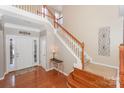 Two-story entry with hardwood floors, a staircase, and a console table at 626 Lorain Nw Ave, Concord, NC 28027