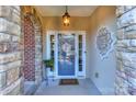 Inviting front entry with a blue door, stone accents, and decorative wreath at 626 Lorain Nw Ave, Concord, NC 28027