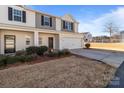 Two-story townhome with attached garage and landscaping at 8138 Paw Club Dr, Charlotte, NC 28214