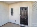 Side entrance with black door and small window at 8138 Paw Club Dr, Charlotte, NC 28214