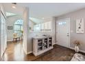 Inviting entryway with hardwood floors, cabinet, and views into the living spaces at 8636 Robinson Forest Dr, Charlotte, NC 28277