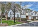 View of the exterior showing landscaping, walkway, and architectural details of the townhome at 8636 Robinson Forest Dr, Charlotte, NC 28277