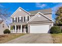 Two-story house with gray siding, white trim, and a two-car garage at 9150 Austin Ridge Ln, Charlotte, NC 28214