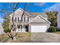 Two-story house with gray siding, white trim, and a two-car garage at 9150 Austin Ridge Ln, Charlotte, NC 28214