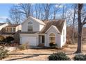 Two-story house with gray siding, a white garage door, and landscaping at 9600 Kayce Ln, Charlotte, NC 28213