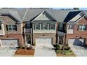 Aerial view of townhouses with attached garages and a central pond at 10715 Campbell Commons Way, Charlotte, NC 28277