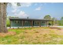 Inviting one-story home with a covered front porch, brick facade, and a spacious front yard with mature trees at 1410 Mays Chapel Church Rd, Newton, NC 28658
