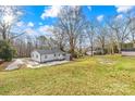 View of the backyard, showing a shed and a mostly flat grassy area at 1449 Cherryville Rd, Shelby, NC 28150