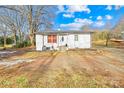 White single story home with gravel driveway and mature trees at 1449 Cherryville Rd, Shelby, NC 28150