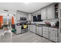 Spacious kitchen with gray cabinets, stainless steel appliances, and granite countertops at 1449 Cherryville Rd, Shelby, NC 28150