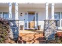 Front entry with stone columns and brick steps at 148 Tarrington Dr, Statesville, NC 28625