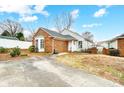 Brick and white sided home with a small yard and driveway at 1749 Ridgefield Ct, Rock Hill, SC 29732