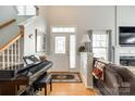 Bright entryway with hardwood floors, piano, and view of the staircase at 318 Rose Garden Ct, Rock Hill, SC 29732