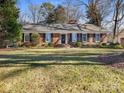 Charming brick ranch house with a spacious lawn and mature trees at 3801 Champaign St, Charlotte, NC 28210