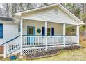 Inviting front porch with white railings and blue accents at 4140 Dye Rd, Edgemoor, SC 29712