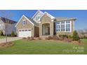 Attractive two-story home with stone exterior and landscaping at 45528 Misty Bluff Dr, Charlotte, NC 28278