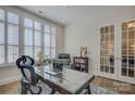 Home office with built-ins, hardwood floors, and natural light at 45528 Misty Bluff Dr, Charlotte, NC 28278